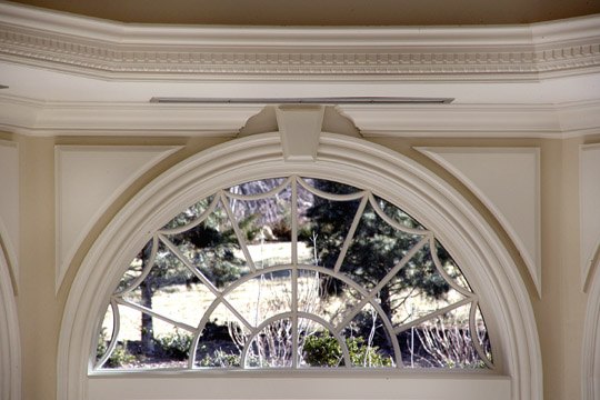 Arched Palladian window with leaded glazing set in a moulded surround