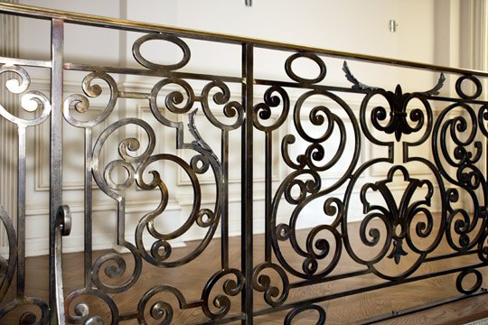 Hand-forged wrought iron stair railing in an Alliotts residence